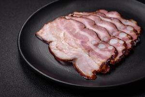 Delicious fresh pancetta or bacon with salt and spices cut into thin slices photo