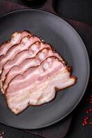 Delicious fresh pancetta or bacon with salt and spices cut into thin slices photo