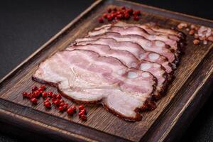 Delicious fresh pancetta or bacon with salt and spices cut into thin slices photo