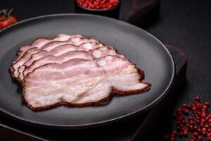 Delicious fresh pancetta or bacon with salt and spices cut into thin slices photo