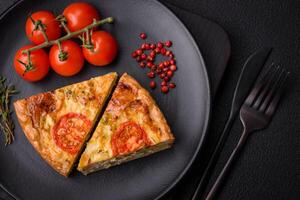 Delicious quiche with tomato, cheese, chicken, spices and herbs photo