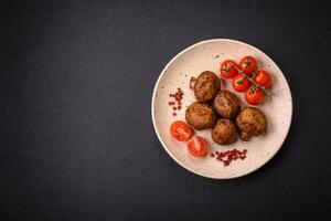 Delicious juicy whole champignons baked on the grill with salt and spices photo