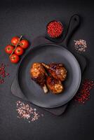 Delicious grilled chicken legs with spices and herbs in teriyaki sauce photo