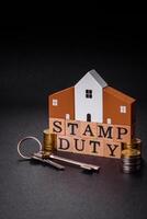 The inscription Stamp Duty made of wooden cubes on a plain background photo