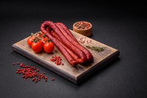 Delicious thin smoked hunting sausages with salt, spices and herbs photo