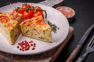 Delicious quiche with tomato, cheese, chicken, spices and herbs photo