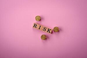 The inscription Risk made of wooden cubes on a plain background photo