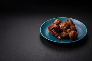 Delicious grilled chicken legs with spices and herbs in teriyaki sauce photo