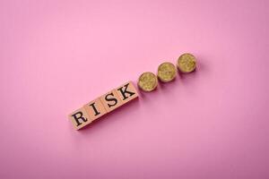 The inscription Risk made of wooden cubes on a plain background photo