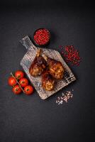 Delicious grilled chicken legs with spices and herbs in teriyaki sauce photo