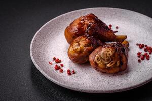 Delicious grilled chicken legs with spices and herbs in teriyaki sauce photo