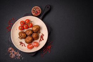 Delicious juicy whole champignons baked on the grill with salt and spices photo