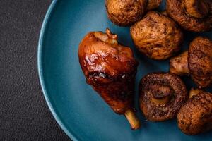 Delicious grilled chicken legs with spices and herbs in teriyaki sauce photo