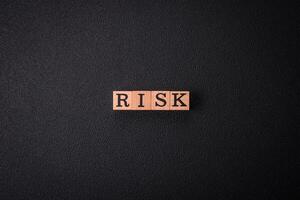 The inscription Risk made of wooden cubes on a plain background photo