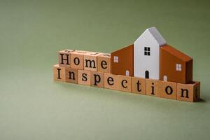 The inscription Home inspection made of wooden cubes on a plain background photo