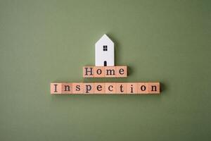 The inscription Home inspection made of wooden cubes on a plain background photo