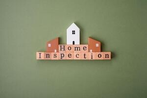 The inscription Home inspection made of wooden cubes on a plain background photo