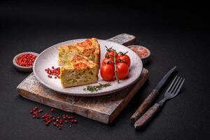 Delicious quiche with tomato, cheese, chicken, spices and herbs photo