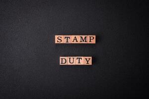 The inscription Stamp Duty made of wooden cubes on a plain background photo