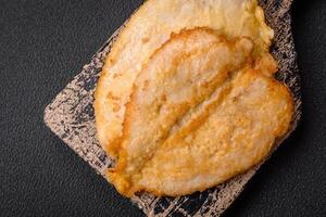 Delicious battered chicken breast chops with salt, spices and herbs photo