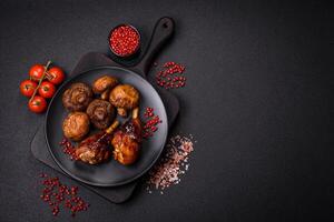 Delicious grilled chicken legs with spices and herbs in teriyaki sauce photo