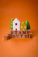 The inscription Stamp Duty made of wooden cubes on a plain background photo