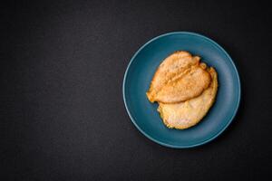 Delicious battered chicken breast chops with salt, spices and herbs photo