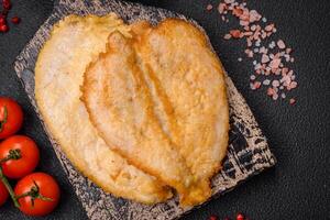 Delicious battered chicken breast chops with salt, spices and herbs photo