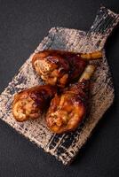 Delicious grilled chicken legs with spices and herbs in teriyaki sauce photo