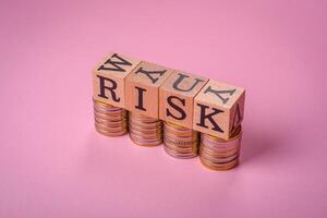 The inscription Risk made of wooden cubes on a plain background photo