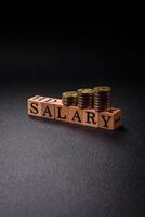 The inscription Salary made of wooden cubes on a plain background photo