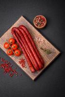 Delicious thin smoked hunting sausages with salt, spices and herbs photo