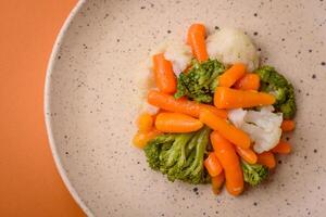 Delicious fresh vegetables broccoli, cauliflower, carrots steamed with salt and spices photo