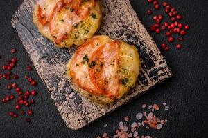 Delicious baked fish fillet with cheese, tomatoes, salt, spices and herbs photo