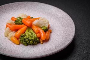 Delicious fresh vegetables broccoli, cauliflower, carrots steamed with salt and spices photo