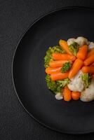 Delicious fresh vegetables broccoli, cauliflower, carrots steamed with salt and spices photo