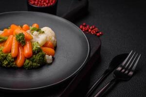 Delicious fresh vegetables broccoli, cauliflower, carrots steamed with salt and spices photo