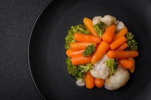 Delicious fresh vegetables broccoli, cauliflower, carrots steamed with salt and spices photo