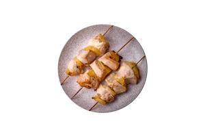 Delicious chicken or turkey kebab with pineapple pieces on skewers photo