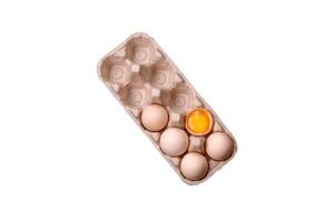 Raw chicken eggs in a box, cherry tomatoes, chickpeas, spices, salt and herbs photo