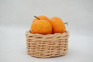 Fresh tangerines in a basket on white background, stock photo