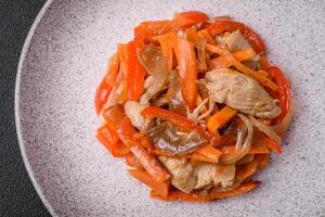 Delicious fresh stew with chicken or turkey with slices of sweet pepper and carrots photo