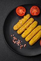 Delicious crispy cheese sticks with mozzarella, salt and spices, breaded and fried in oil photo