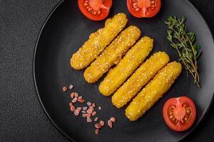 Delicious crispy cheese sticks with mozzarella, salt and spices, breaded and fried in oil photo