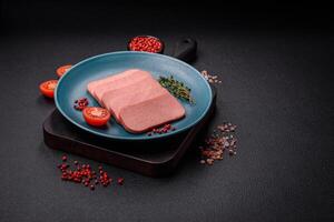 Delicious canned pink ham with salt, spices and herbs photo