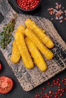 Delicious crispy cheese sticks with mozzarella, salt and spices, breaded and fried in oil photo