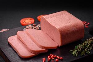 Delicious canned pink ham with salt, spices and herbs photo