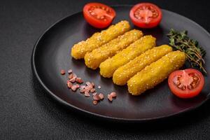 Delicious crispy cheese sticks with mozzarella, salt and spices, breaded and fried in oil photo