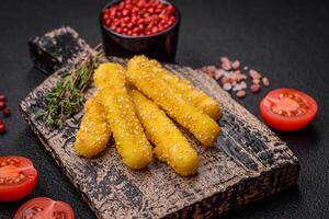 Delicious crispy cheese sticks with mozzarella, salt and spices, breaded and fried in oil photo