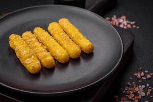 Delicious crispy cheese sticks with mozzarella, salt and spices, breaded and fried in oil photo